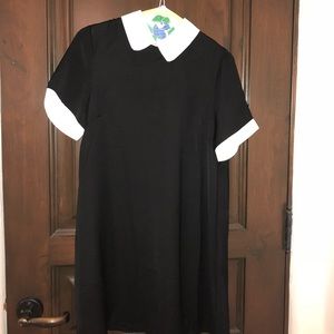 A black dress with a white collar